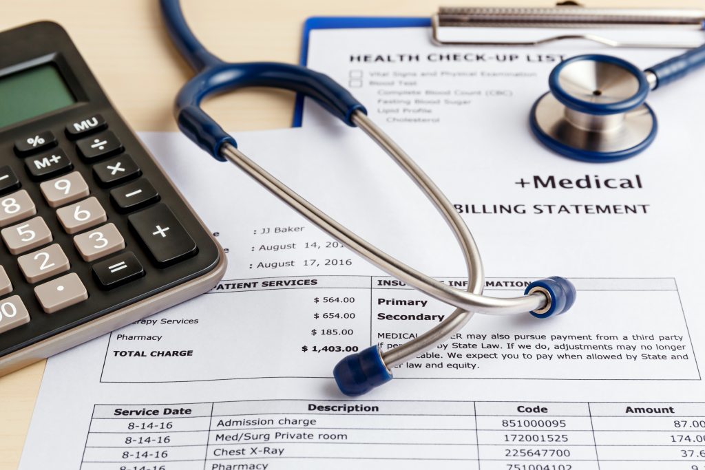 Medical bill with calculator and stethoscope
